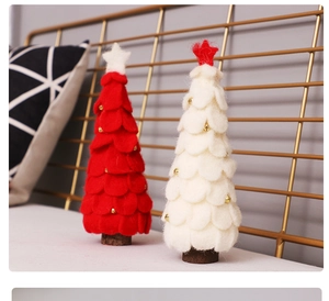 Detail of red and white wool felt Christmas trees with golden stars and bells