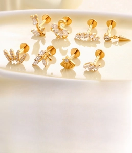 Detailed set of titanium cartilage studs with zirconia in star and leaf shapes