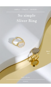 Close-up of minimalist gold-plated silver ring with inset moonstone and crystal stones