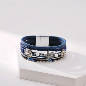 Close-up of multilayer leather bracelet with starfish, turtle charms and magnetic clasp