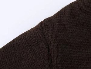Détail de la couture d'épaule et texture du cardigan en maille marron foncé