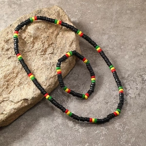 Elastic set of black wooden bead necklace and bracelet on a natural stone base