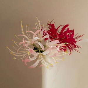 Detail of red and white lycoris hair clip showing intricate petals and long stamens