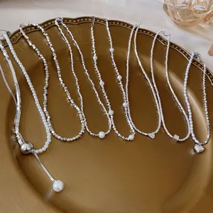 Luxury silver-tone necklace and bracelet set with pearls and heart pendants on a tray