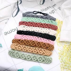 Detail showing various colors of handmade woven cotton hairbands with braided texture
