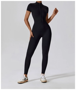 Close-up of black short-sleeve jumpsuit featuring a front zipper and high-stretch fabric
