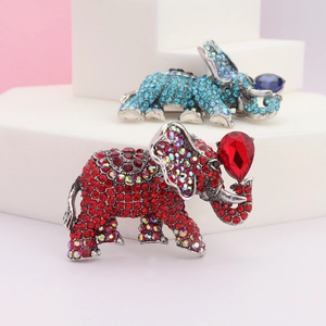 Detailed view of vintage elephant brooches with colorful rhinestones and pear-cut stones