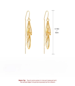 Macro detail of gold long tassel earrings with drop pendants in high-quality alloy