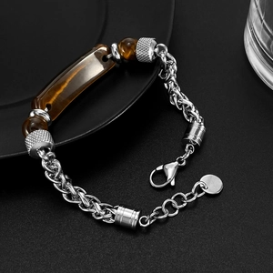 Detail of silver stainless steel chain bracelet with a rectangular tiger eye stone for men