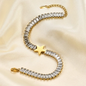 Detail of gold star bracelet with rectangular zircons on champagne silk backdrop