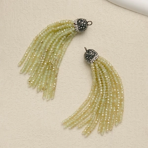 Close-up of light green faceted bead tassels with rhinestone metal caps for DIY jewelry