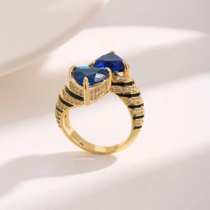 Chic gold ring with blue heart stones, black enamel stripes and shimmering zircon details
