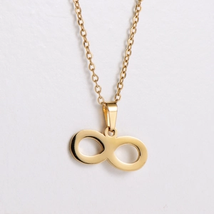 Macro detail of golden infinity symbol pendant with high polish finish on necklace