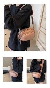Close-up of pink multi-layer crossbody camera bag with lychee texture and wide strap
