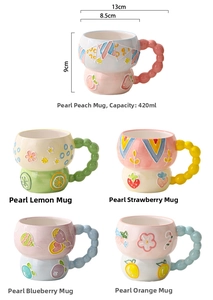 Detail of 420ml relief ceramic mugs with fruit patterns and beaded handles