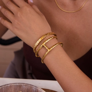 Macro detail of 18K gold-plated double-layer hammered stainless steel open bangle