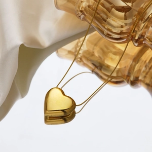 Collier minimaliste à pendentif cœur doré sur chaîne serpent avec reflet miroir