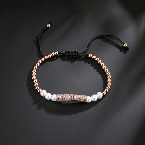 Detail of adjustable woven bracelet with rose gold beads and colorful zircon cylinder
