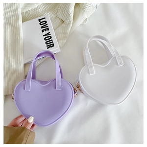 Top view of mini heart-shaped handbags in purple and white PVC with metallic D-ring details