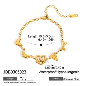 Detail shot of 18K gold stainless steel bracelet with heart and croissant charms