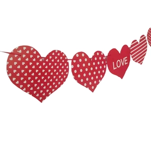 Detail of red and white heart banner bunting with LOVE text for romantic party decoration