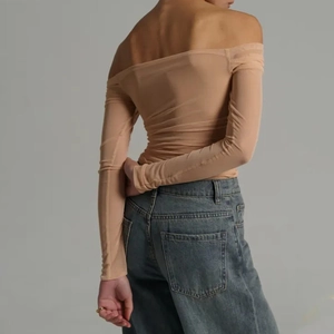 Detail view showing the back of a beige off-the-shoulder long sleeve mesh top with ruching