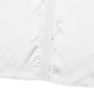 Detail view of the white dress showing clean double-needle stitching and smooth fabric hem