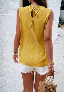 Back view of a yellow sleeveless top featuring dot texture and elegant neck tie detail