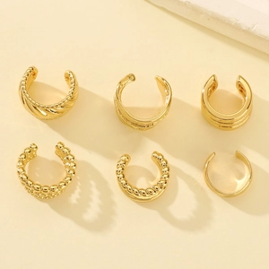 Set of 6 gold ear cuffs including twisted, beaded, and polished minimalist designs