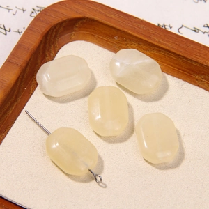 Macro detail of rectangular natural stone beads in light yellow and white for jewelry DIY