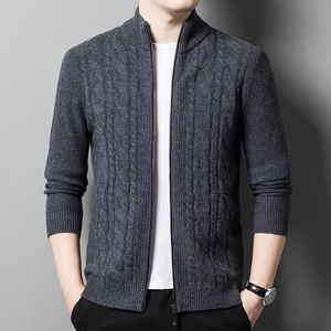 Detail of grey knitted cardigan showing waffle and cable knit patterns with metal zipper