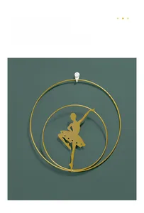 Golden ballet dancer wall art with double-ring metal frame on dark green wall