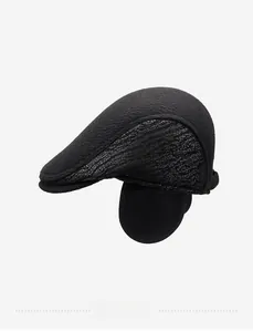 Detail of winter men's black wool flat cap with ear flaps and thick warm texture