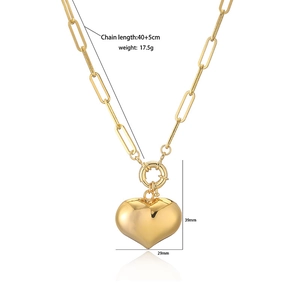Minimalist gold heart pendant necklace with paperclip chain and spring clasp closure