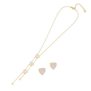 Golden heart jewelry set with white shell inlay and sparkling crystals on white backdrop