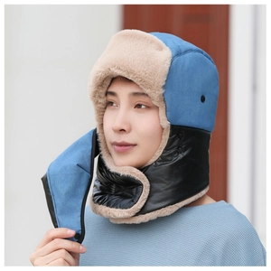 Detail of winter trapper hat with blue fabric, warm fleece lining and windproof face mask