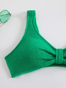 Detail of green textured seersucker bikini top with stylish one-shoulder design