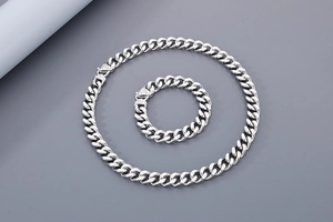 Detailed view of silver men's curb link jewelry set with necklace and bracelet