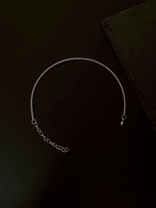 Detail shot of a silver double-layered chain bracelet with extension and clasp
