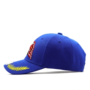 Detailed embroidery of gold laurel leaves on a royal blue cotton baseball cap brim