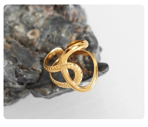 Detail of twisted spiral ring in 18K gold plating on a dark mineral stone