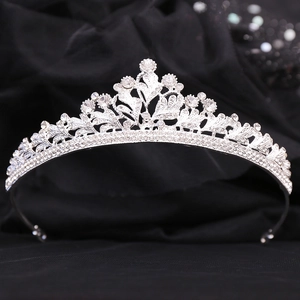 Detailed view of bridal tiara with sparkling crystal leaves and floral metal patterns