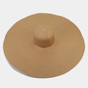 Close-up of tight weave texture on oversized straw sun hat for beach UV protection