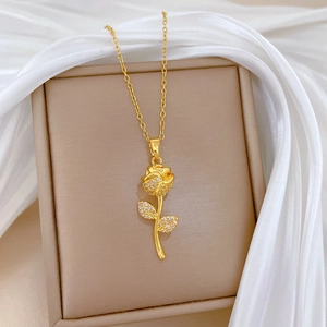 Elegant rose gold necklace with crystal-inlaid flower pendant on beige jewelry box