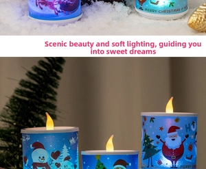 Detail view of blue Christmas LED candle with Santa and reindeer prints among pine cones