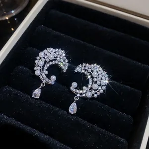 Elegant moon-shaped pearl earrings with sparkling zircon accents and a teardrop pendant