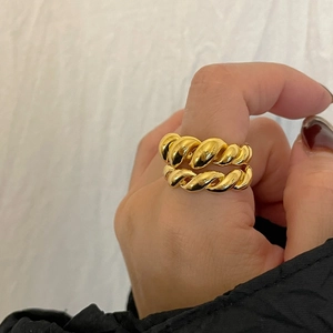 Minimalist 925 sterling silver gold plated rope twist rings stacked on woman's finger