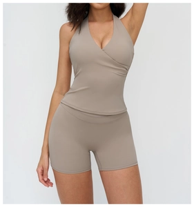 Detail view of V-neck halter yoga top and high waist shorts set in earthy brown