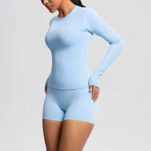 Close-up of sky blue yoga set featuring thumbhole long sleeves and high waist gym shorts