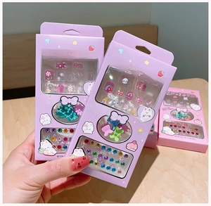 Detail of cartoon nail sticker gift set with colorful hair clips and rainbow rhinestones